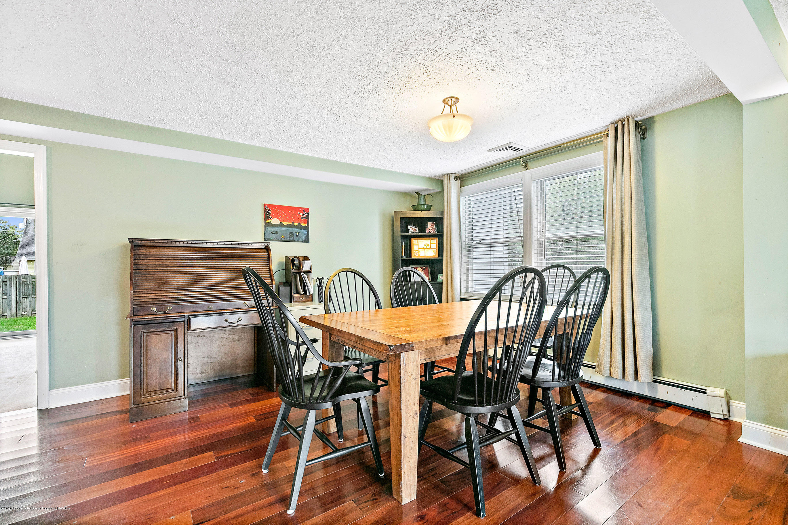 121 Wave Road Manahawkin, NJ 08050 - Photo 13 of 40 a view of a dining room with furniture and wooden floor