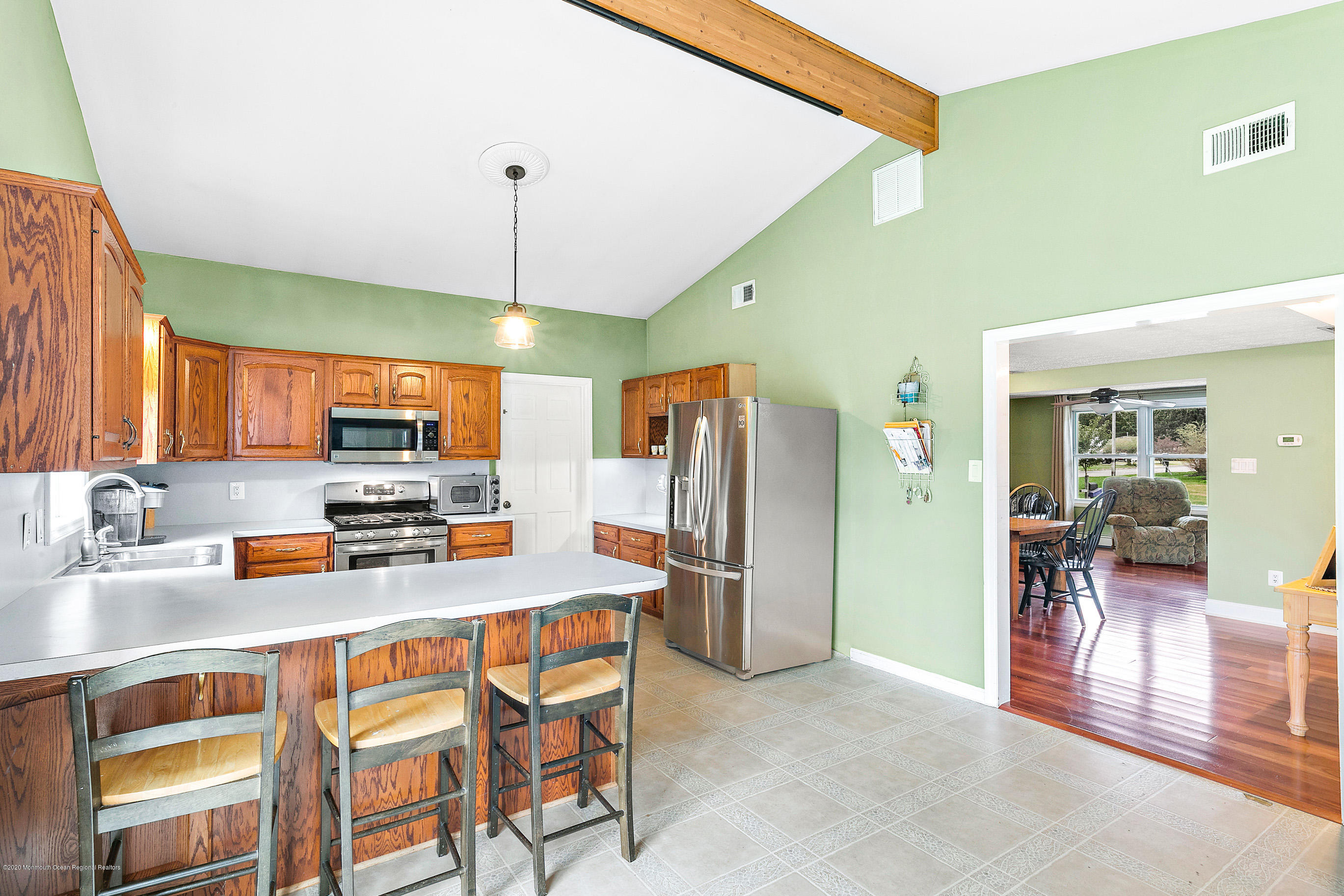121 Wave Road Manahawkin, NJ 08050 - Photo 16 of 40 a kitchen with stainless steel appliances a sink stove and refrigerator