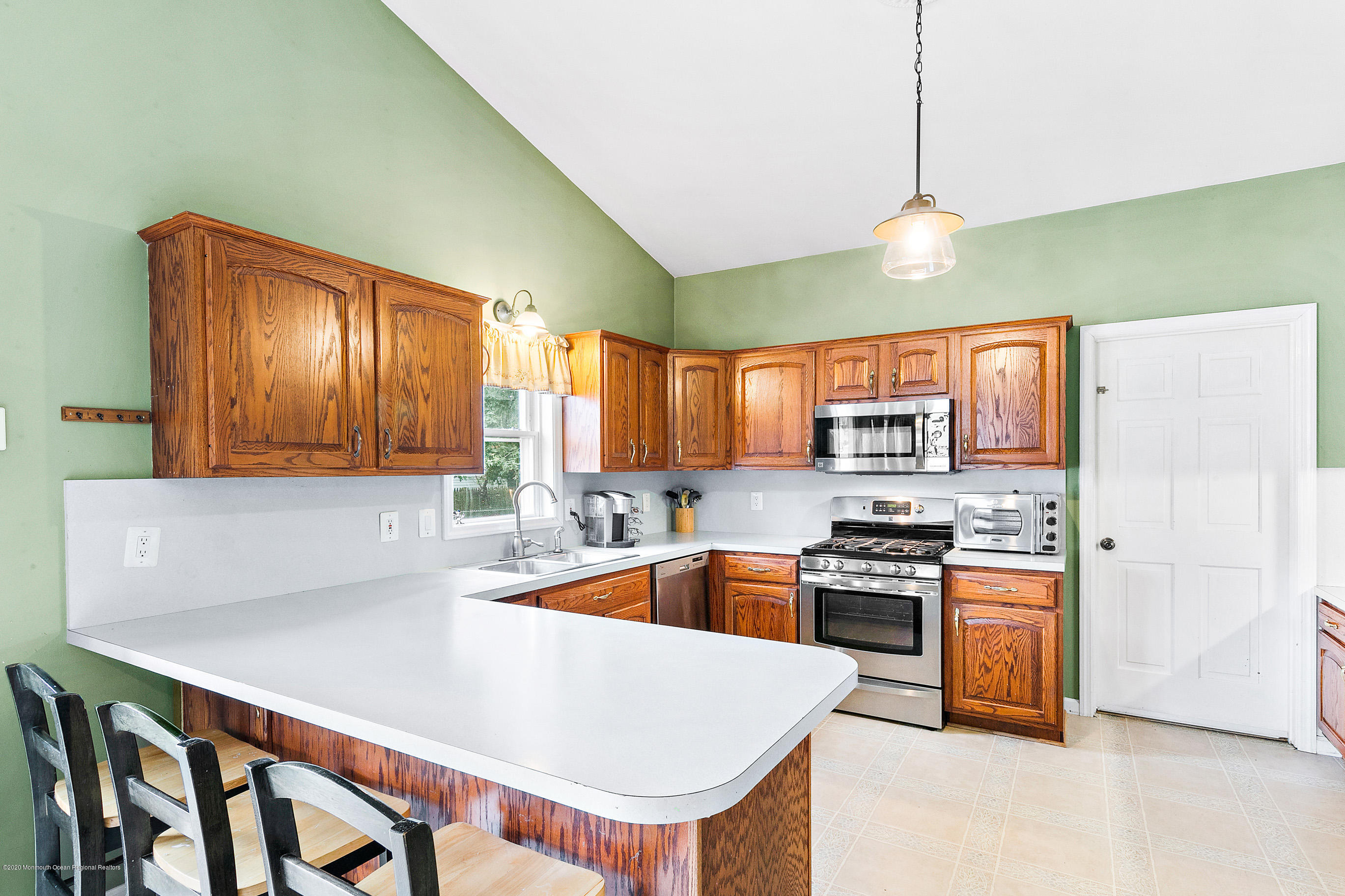 121 Wave Road Manahawkin, NJ 08050 - Photo 17 of 40 a kitchen with stainless steel appliances granite countertop a sink a stove and a refrigerator