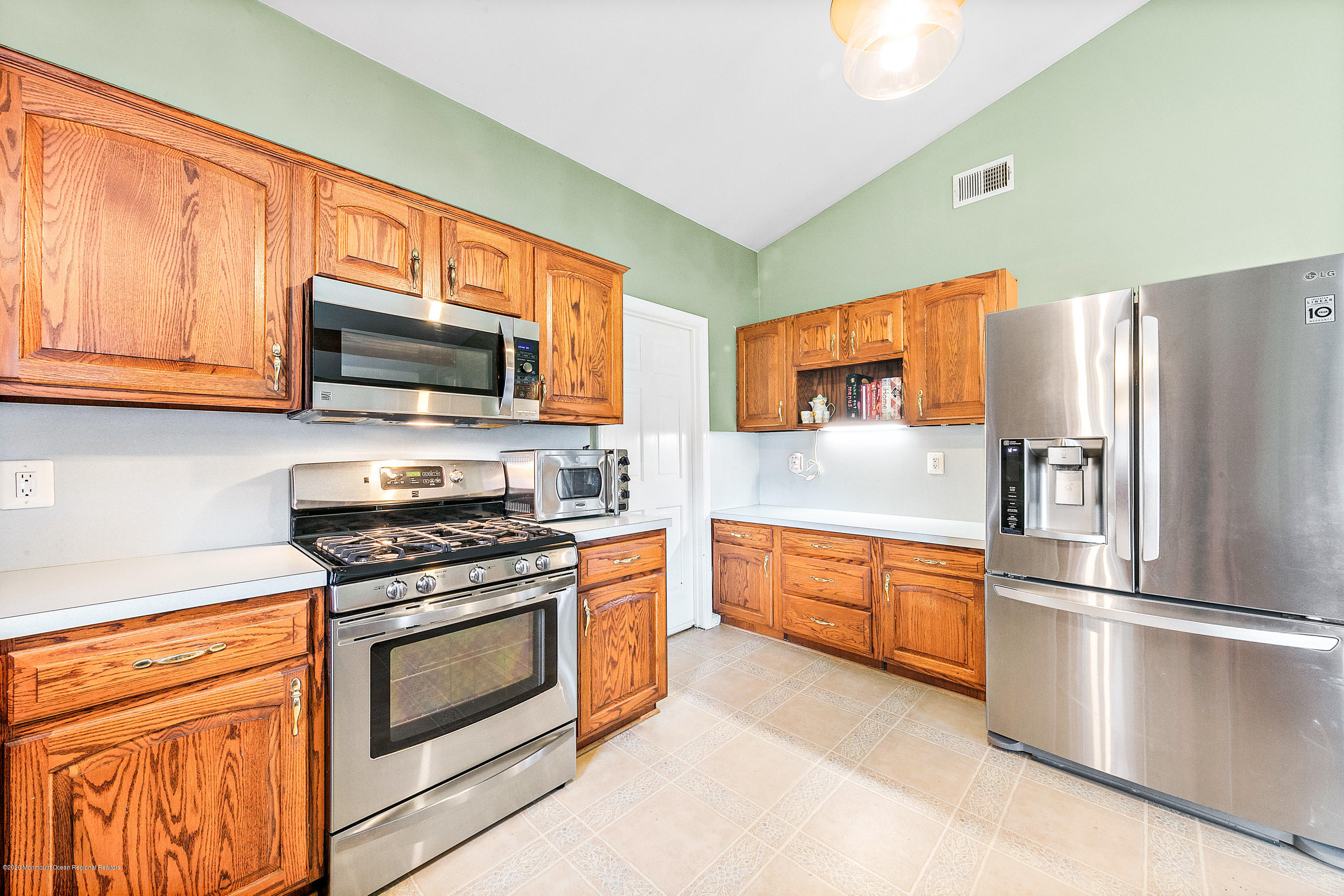 121 Wave Road Manahawkin, NJ 08050 - Photo 19 of 40 a kitchen with stainless steel appliances granite countertop a refrigerator stove microwave and sink