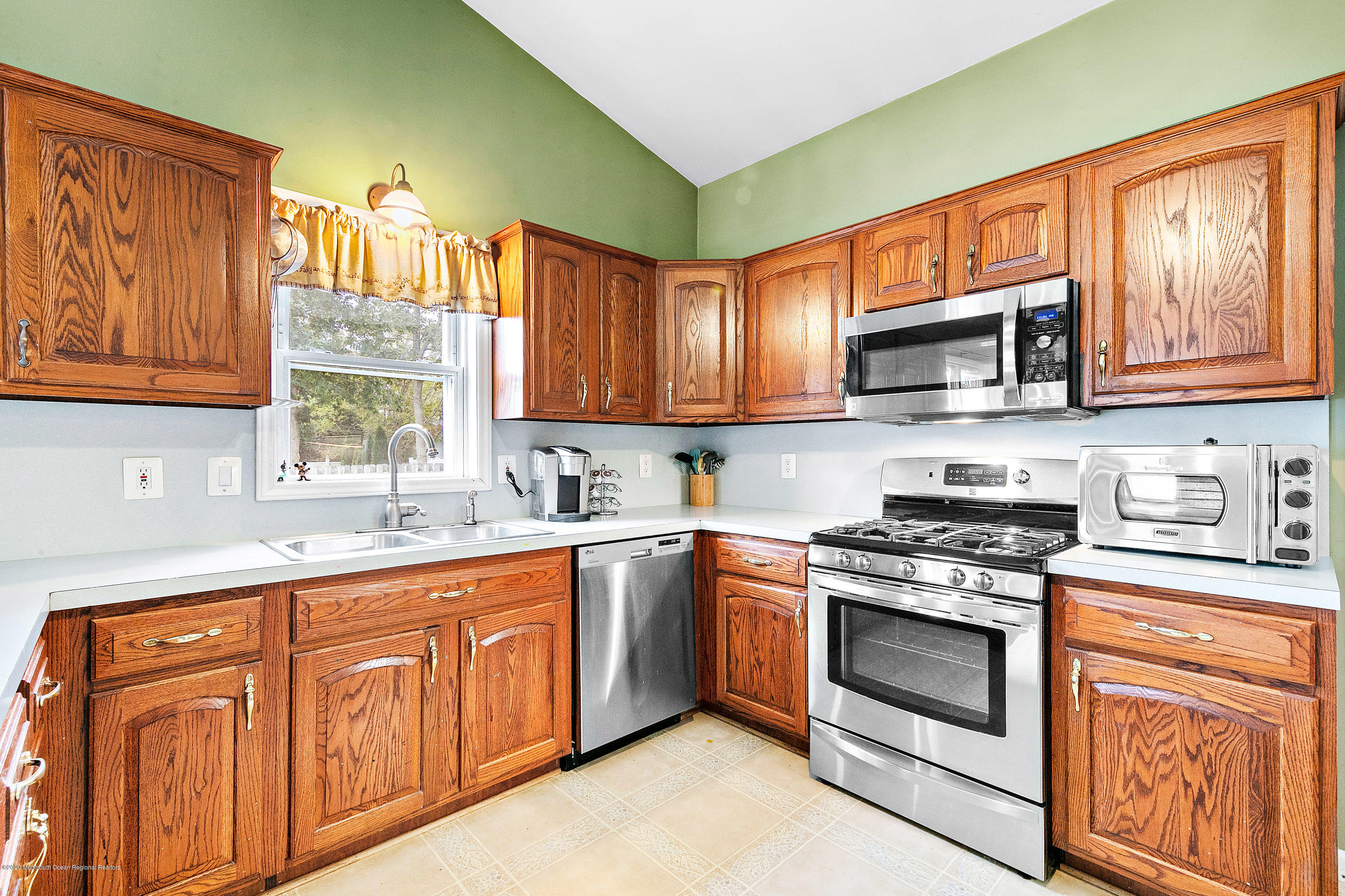 121 Wave Road Manahawkin, NJ 08050 - Photo 21 of 40 a kitchen with stainless steel appliances granite countertop a stove sink microwave and cabinets