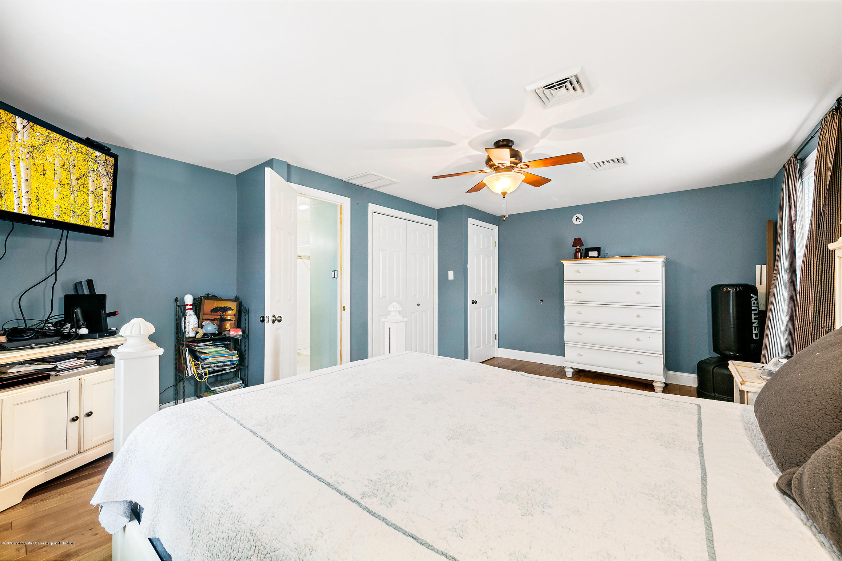 121 Wave Road Manahawkin, NJ 08050 - Photo 29 of 40 a bedroom with a bed and a tv