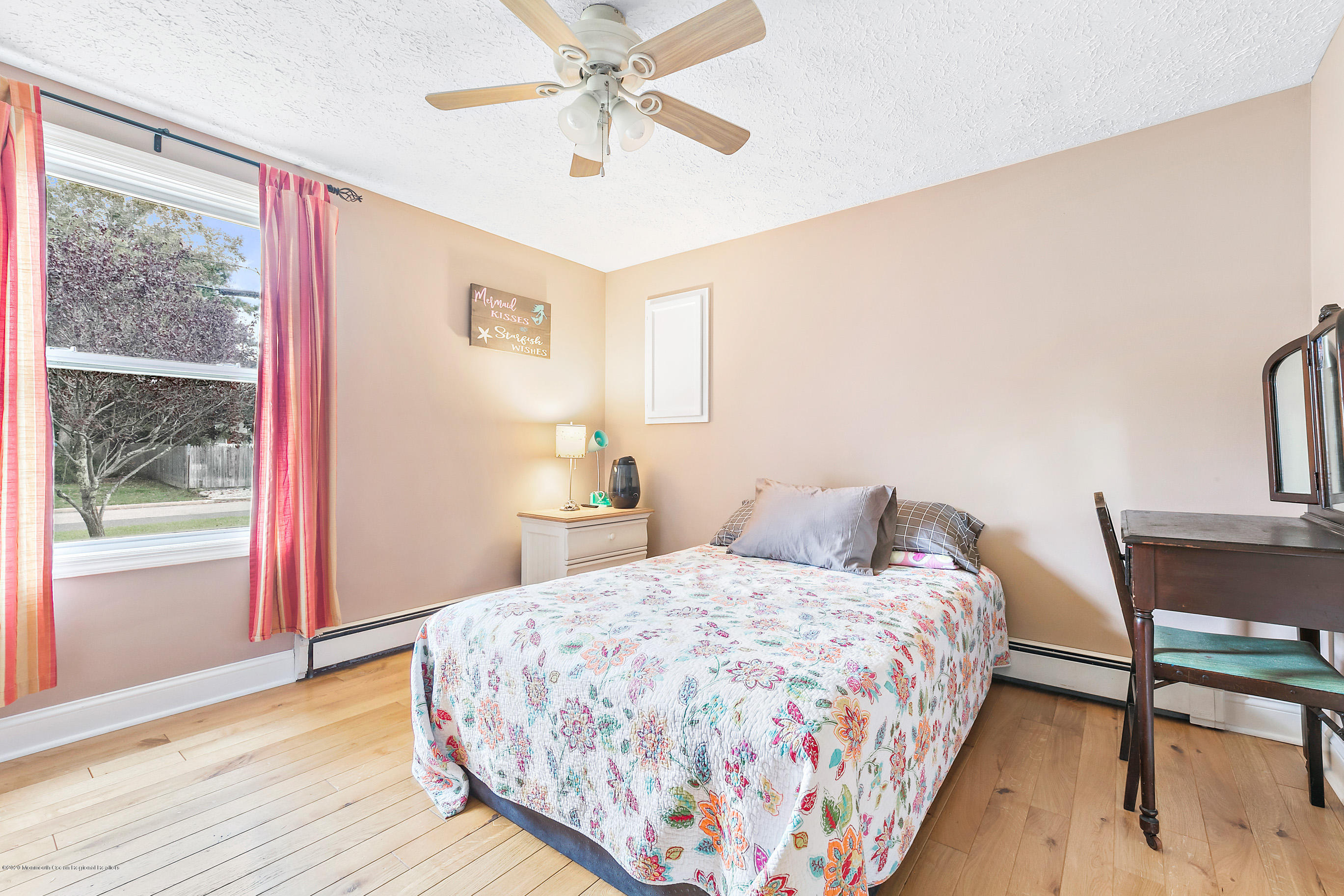 121 Wave Road Manahawkin, NJ 08050 - Photo 33 of 40 a bedroom with a bed and a table