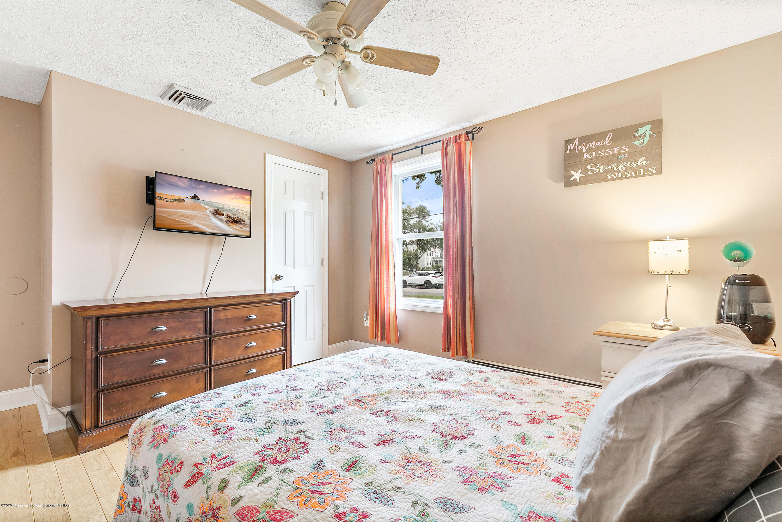 121 Wave Road Manahawkin, NJ 08050 - Photo 34 of 40 a bedroom with a bed and a flat screen tv
