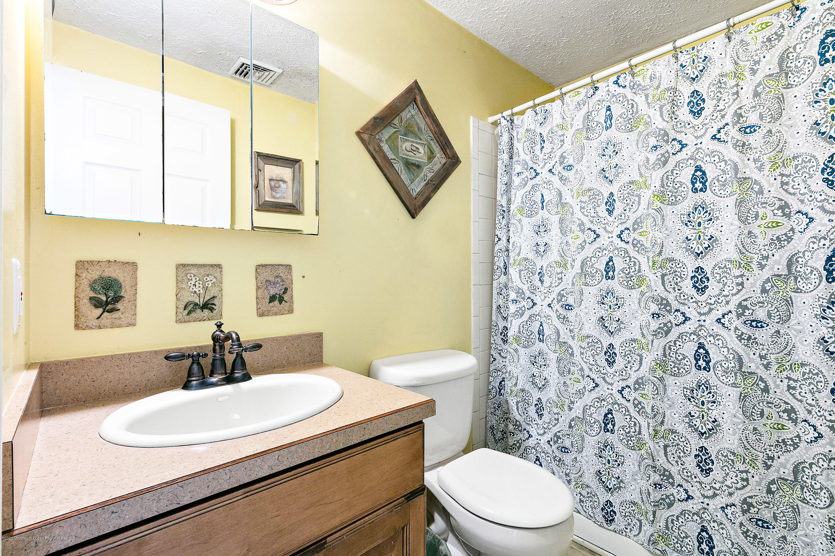 121 Wave Road Manahawkin, NJ 08050 - Photo 35 of 40 a bathroom with a sink a toilet and a mirror