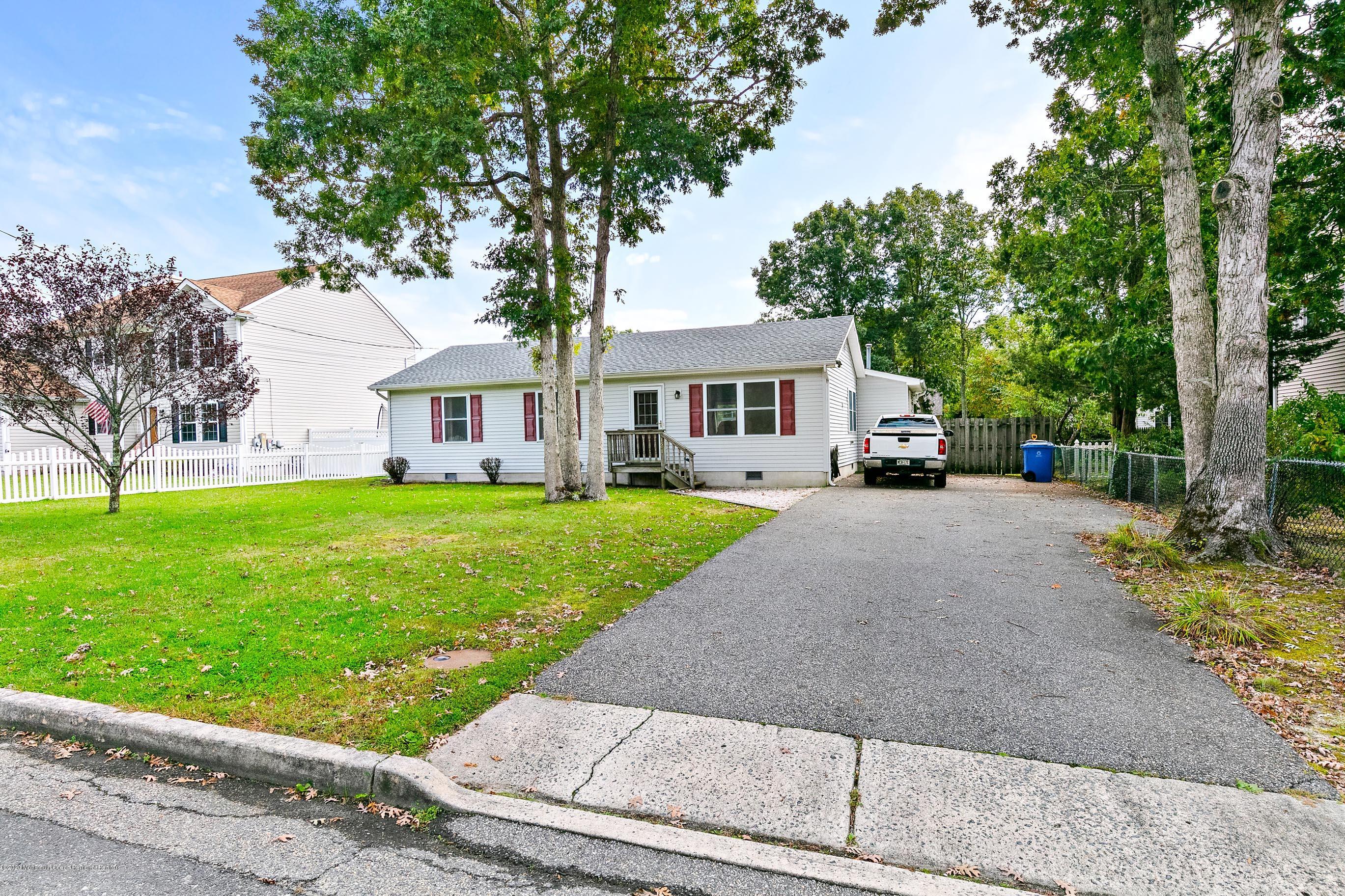 121 Wave Road Manahawkin, NJ 08050 - Photo 4 of 40 a front view of a house with a yard