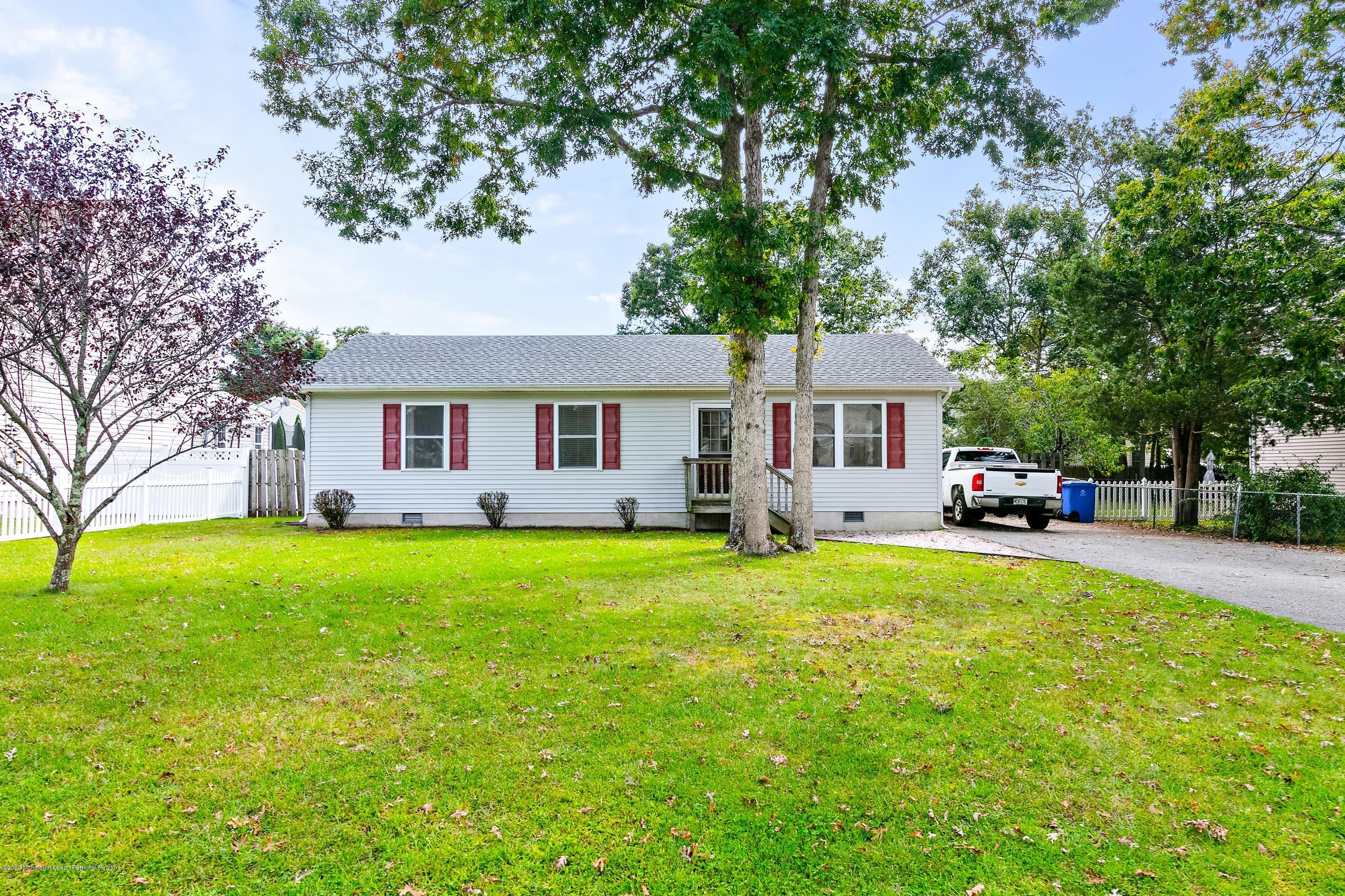 121 Wave Road Manahawkin, NJ 08050 - Photo 6 of 40 a front view of a house with a garden