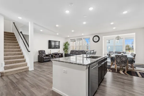 a large kitchen with stainless steel appliances lots of counter space and furniture