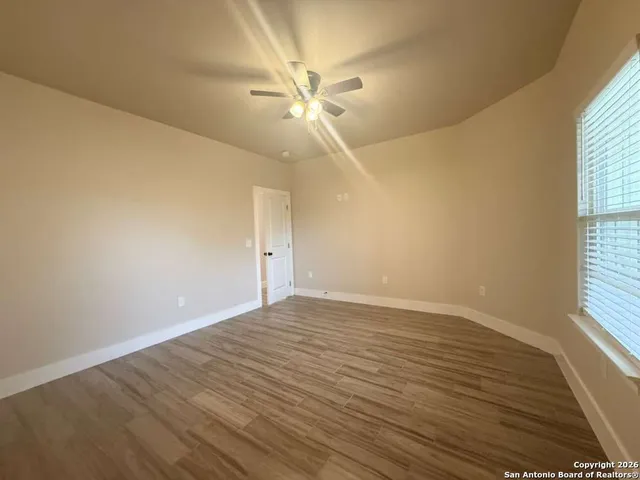 a view of a closet with wooden floor