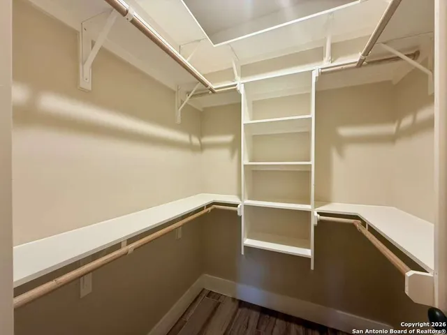a bathroom with a granite countertop shower and a sink