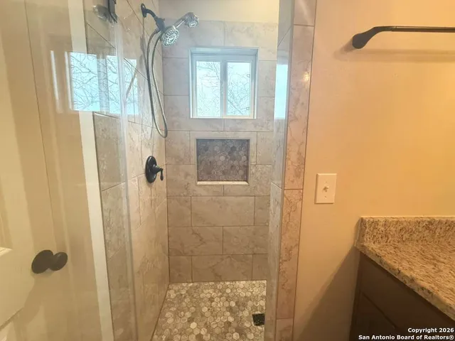 a white toilet sitting next to a bathroom sink and vanity