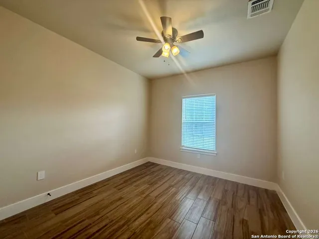 a bathroom with a granite countertop sink toilet a large mirror a bathtub and shower