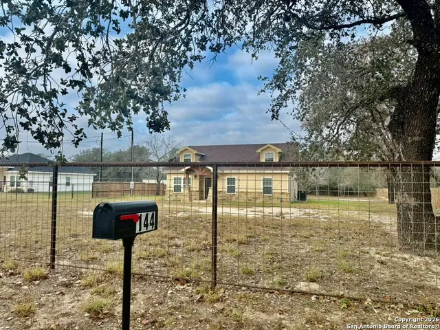 a view of a house with a backyard
