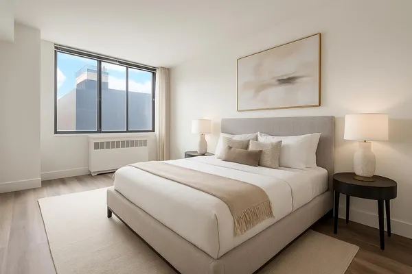 a bedroom with a bed and a painting on the wall