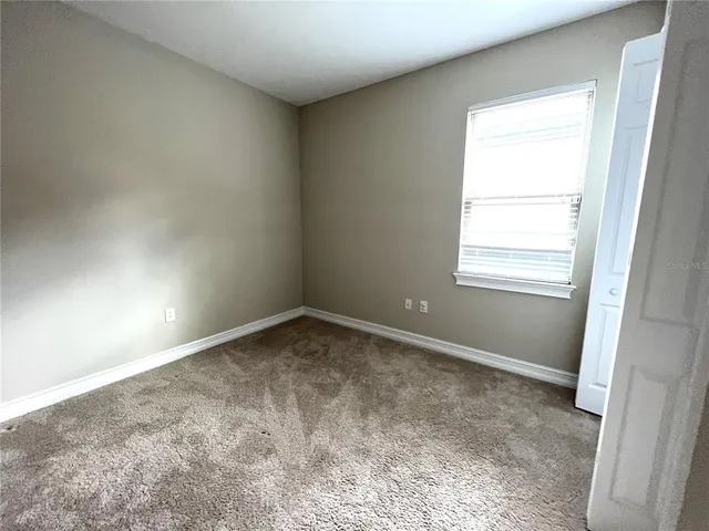 an empty room with a empty space and windows