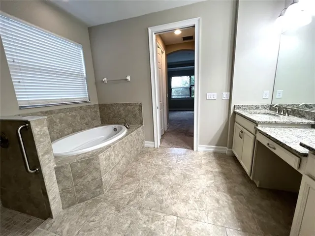 a bathroom with a granite countertop sink toilet a mirror and shower