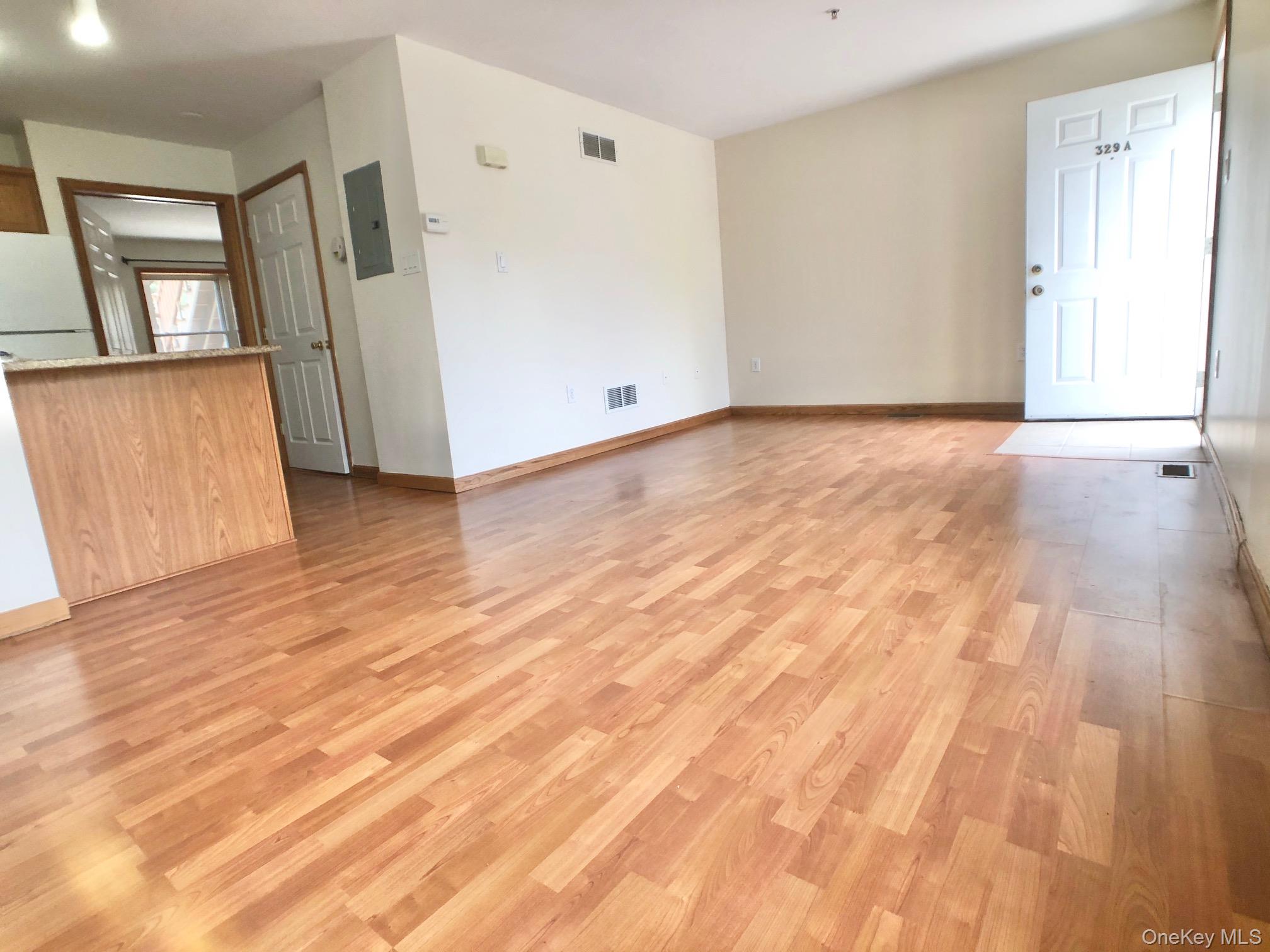 331 West Post Road, Unit A White Plains, NY 10606 - Photo 4 of 9 Unfurnished living room featuring light wood finished floors and electric panel
