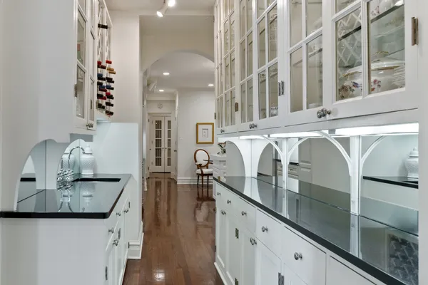 a kitchen with kitchen island granite countertop stainless steel appliances a stove a sink and a refrigerator