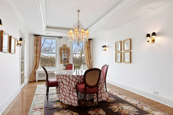a bedroom with a bed a chandelier and closet