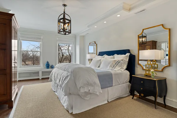 a bedroom with a bed and a large window