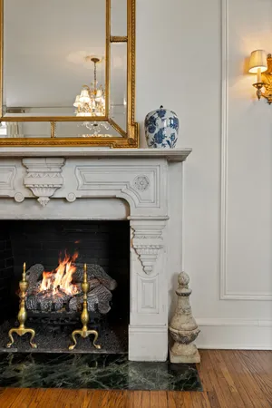a living room with furniture a chandelier and a large mirror
