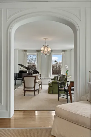 a large white kitchen with a large island oven a stove and a wooden floors