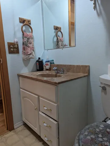 a bathroom with a toilet sink and vanity