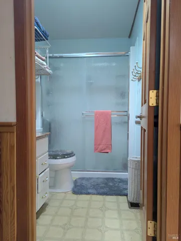 a bathroom with a toilet and a shower