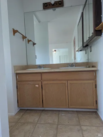 a kitchen with cabinets and white countertops