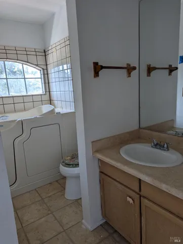 a bathroom with a sink a toilet and a mirror