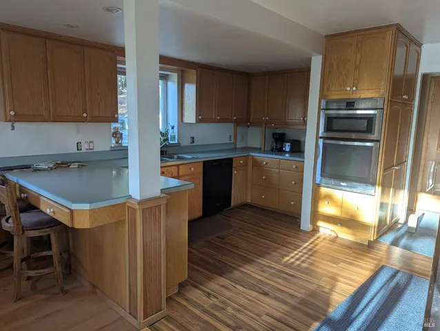 a kitchen with wooden cabinets a sink stove and refrigerator