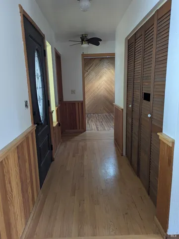 a view of a hallway view with wooden floor and staircase