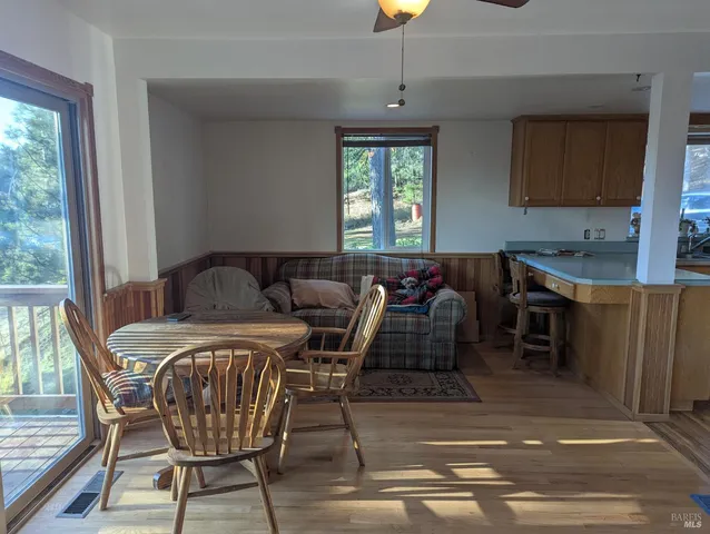 a kitchen with sink dining table and chairs