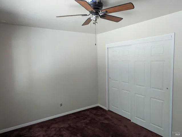 an empty room with a fan