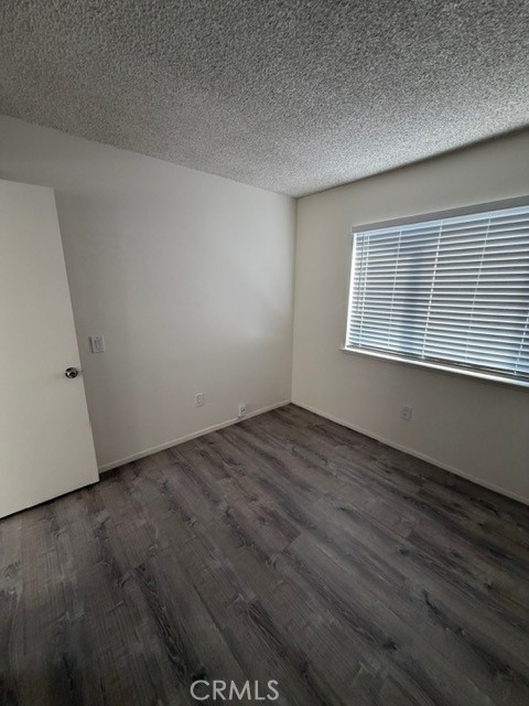 2822 Monroe Street Riverside, CA 92504 - Photo 11 of 13 an empty room with wooden floor and windows