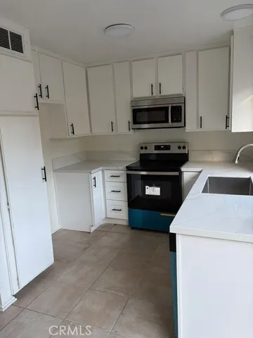 a kitchen with stainless steel appliances granite countertop a sink and a stove