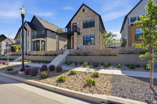 11531 Engelmann Drive Draper, UT 84020 - Photo 2 of 31 Contemporary stone and stucco exterior featuring a second-story balcony with black railings