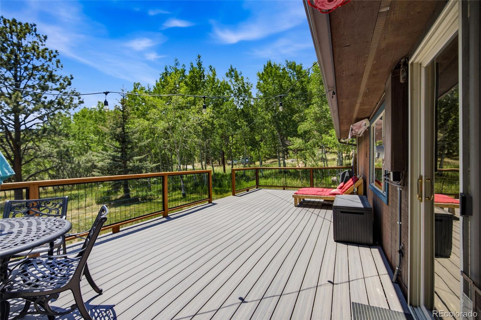31280 Florence Road Conifer, CO 80433 - Photo 26 of 48 a view of balcony with wooden floor and seating space