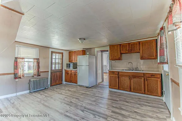 a kitchen with stainless steel appliances granite countertop a refrigerator and cabinets