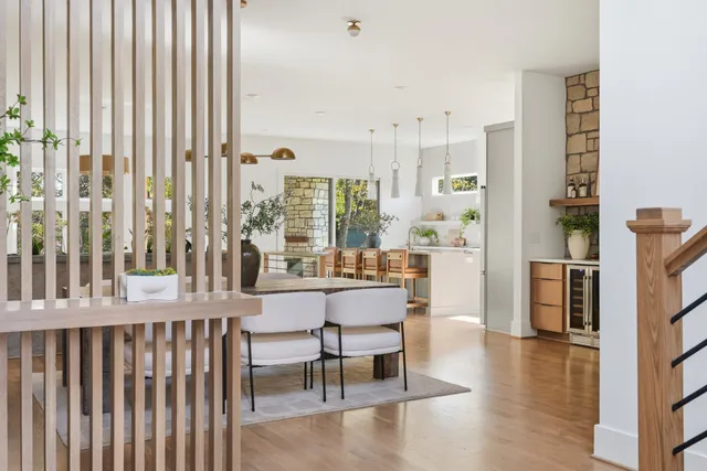 a dining room with furniture and a floor to ceiling window
