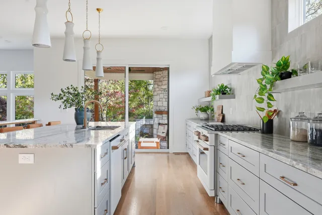 a kitchen with counter top space and wooden floor