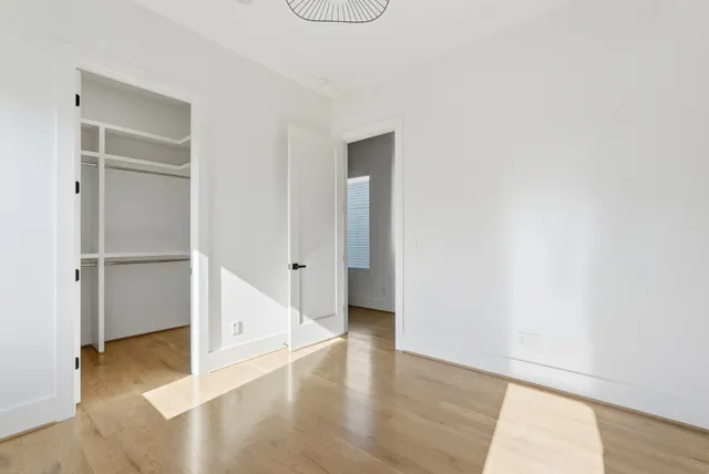 a view of a hallway with wooden floor