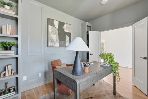 a living room with furniture and a potted plant