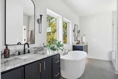 a view of house with backyard and sitting area