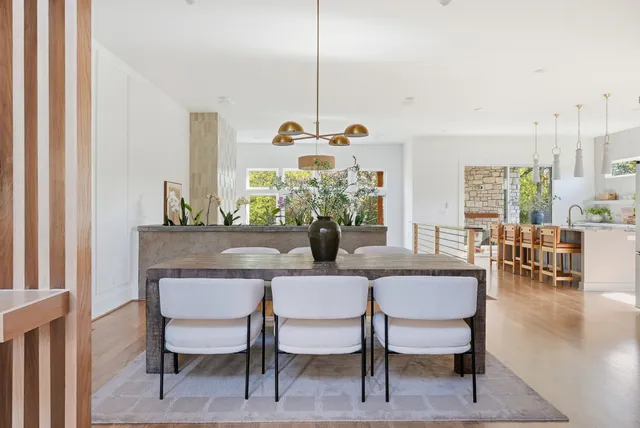 a dining room with furniture a chandelier and wooden floor