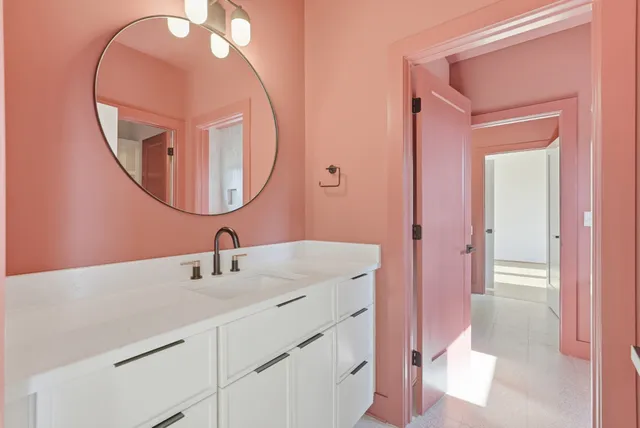 a bathroom with a sink mirror and vanity