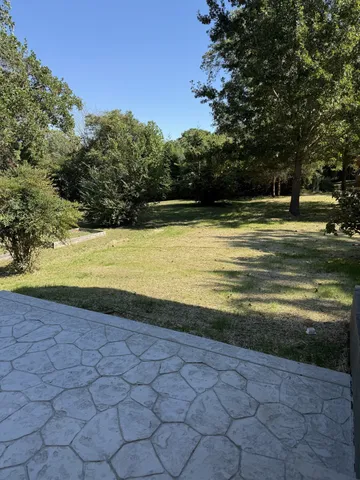 a view of a swimming pool and a yard