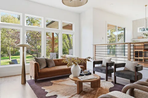 a kitchen with stainless steel appliances granite countertop a stove and a dining table with wooden floor