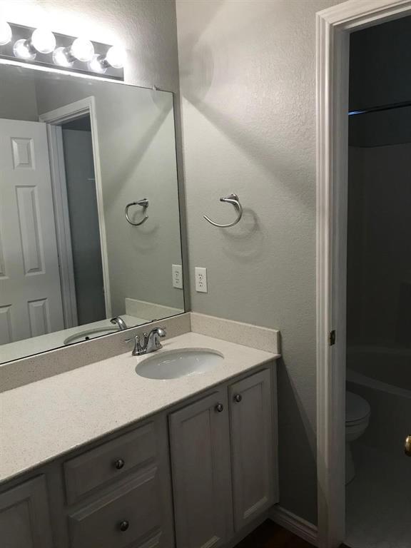 3016 Penniman Road Denton, TX 76209 - Photo 12 of 15 a bathroom with a sink and a mirror