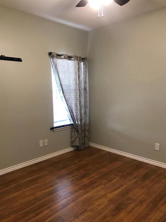 3016 Penniman Road Denton, TX 76209 - Photo 6 of 15 a view of an empty room with wooden floor and a window